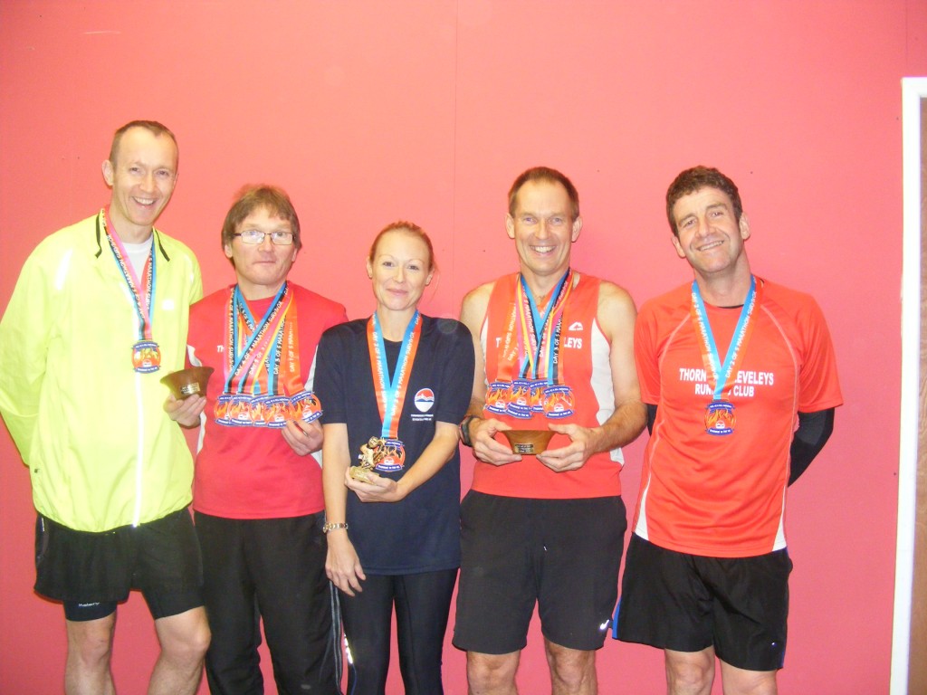 from left Andy Fairbairn, Terry Poole, Jenny Clark, Brian Cumpsty, Steve Livesey with their medals from the Hell of a Hill marathon